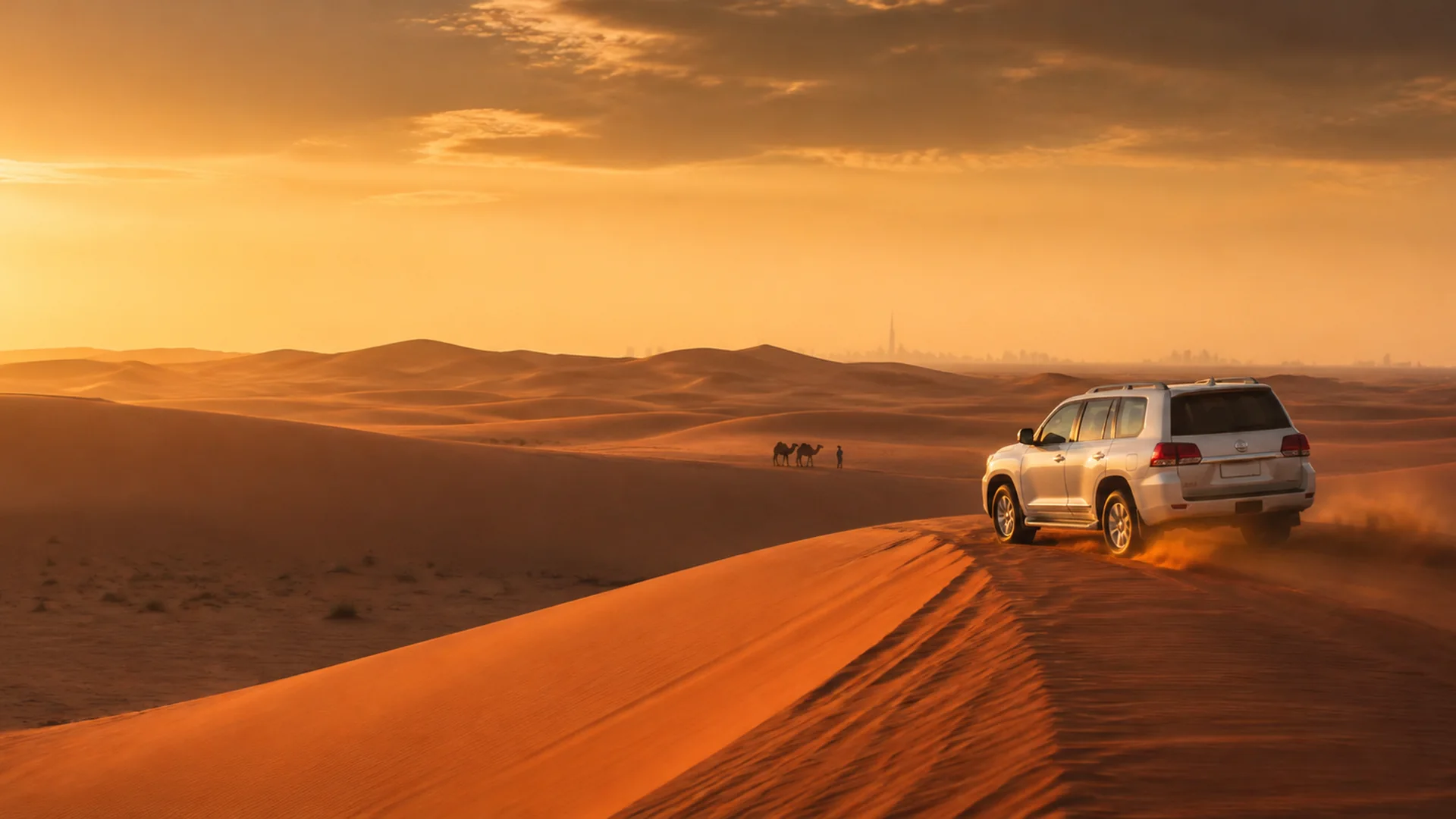 White 4x4 crossing Dubai red dunes at sunset
